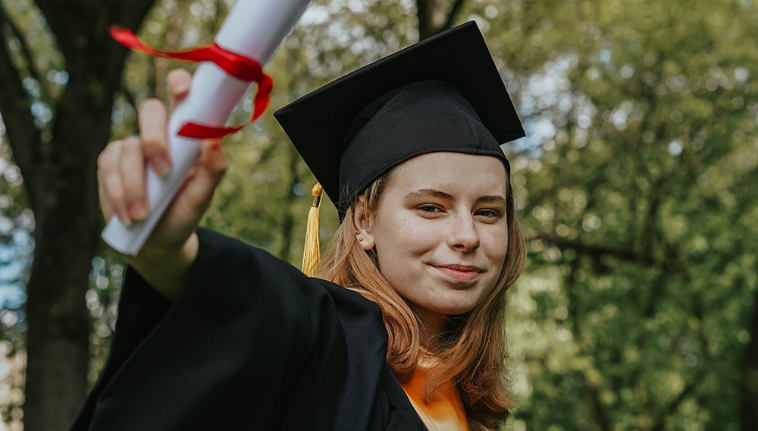 Graduate with degree in hand